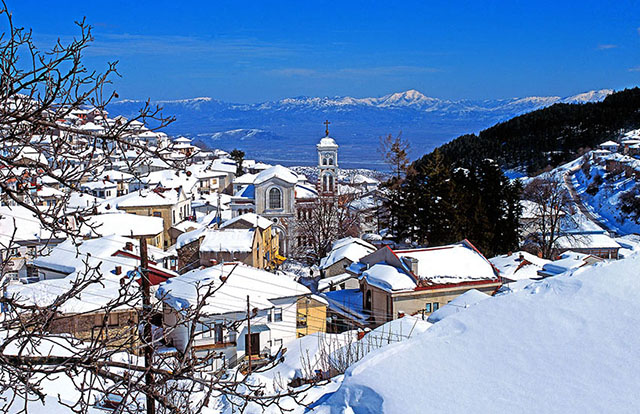 Panoramic view of houses in Krusevo city with snow covered roofs